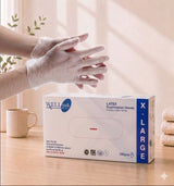 Box of Wellpak latex examination gloves with a person wearing gloves on a table.


