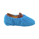 Blue non-slip disposable shoe cover fitted over a brown leather shoe
