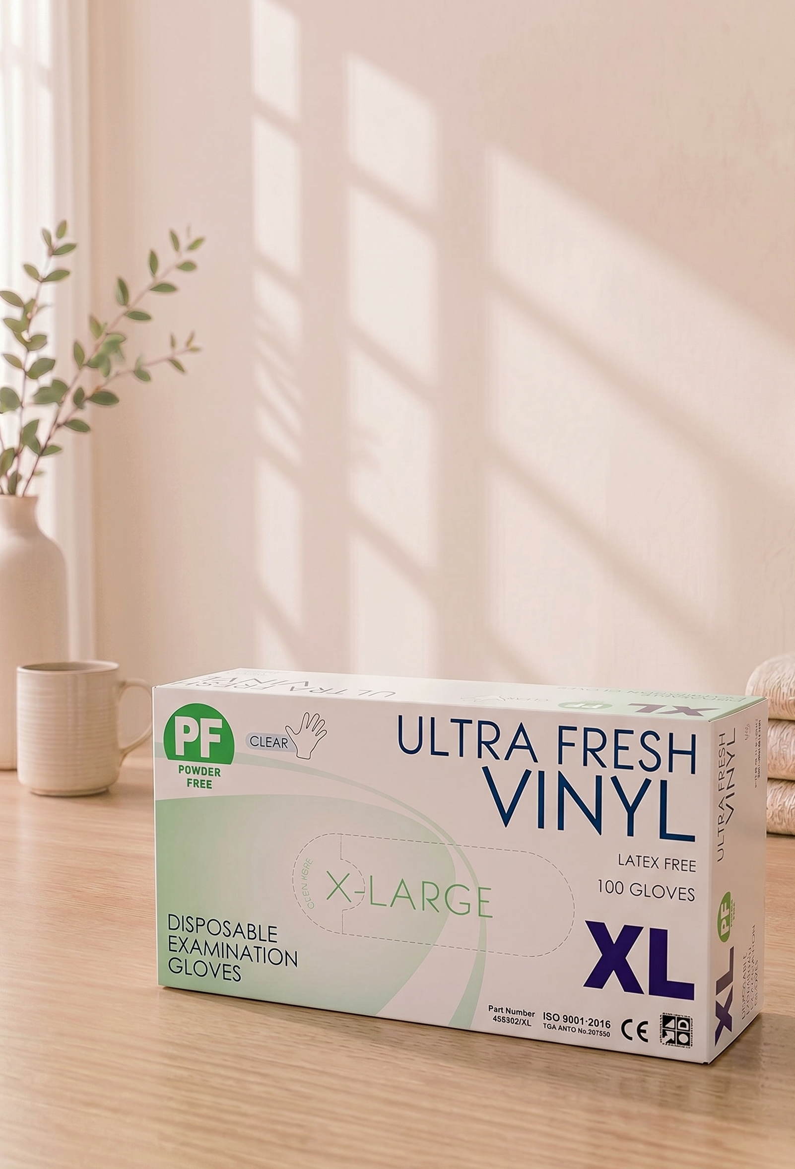 Box of Ultra Fresh Vinyl disposable examination gloves on a wooden surface with a light background


