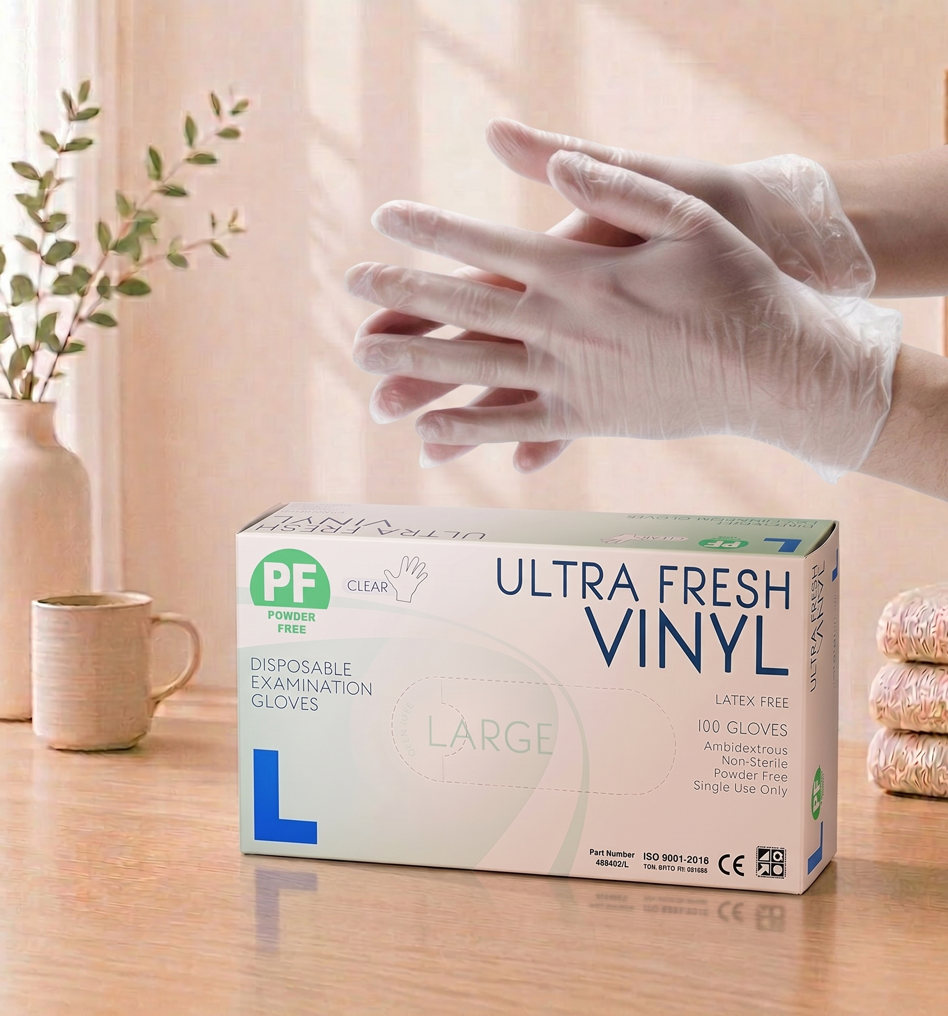 Box of Ultra Fresh Vinyl disposable gloves on a table with a person putting on a glove.


