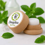 DeepSea Menthol product with wooden lid and green leaves in the background


