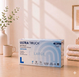 Box of Ultra Touch Nitrile Examination Gloves on a table with a homey background

