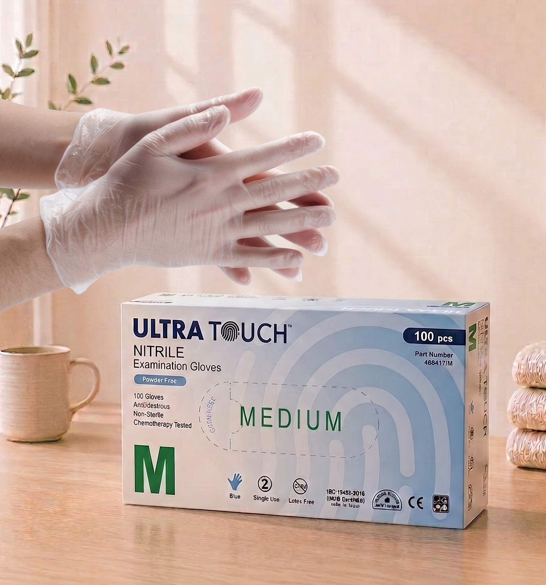 Box of Ultra Touch Nitrile Examination Gloves on a table with hands wearing gloves.

